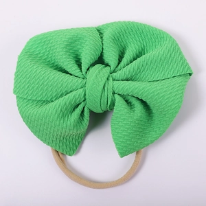 Detail of green bubble fabric double layer bow headband for infants and babies