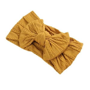 Mustard yellow cable knit baby headband with oversized bow on white background