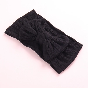 Soft cable-knit baby headband with a large bow in classic black finish for girls