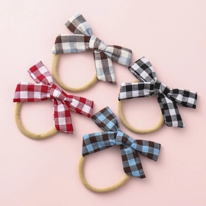 Set of four checkered plaid bow headbands for baby girls in various colors
