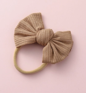 Détail de la texture du tissu côtelé brun sur le nœud et le bandeau élastique en nylon