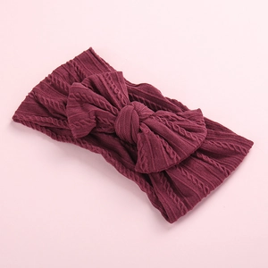 Soft nylon jacquard baby headband with large cable knit bow in dark wine red color