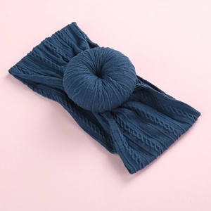 Deep teal cable knit baby headband featuring a soft donut knot design for infants