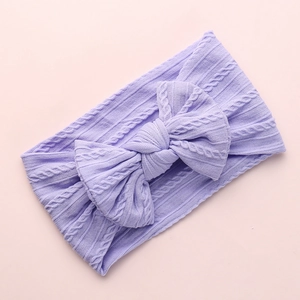 Soft lavender nylon headband for baby girls with a large cable knit jacquard bow