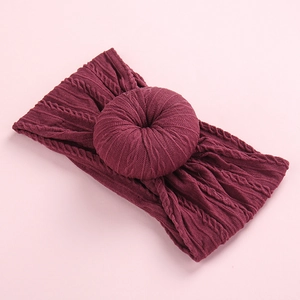 Wine red cable knit baby headband featuring a stylish donut knot and soft fabric