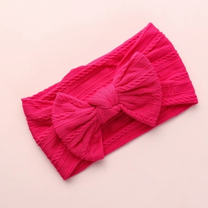 Rose red cable knit baby headband with a large bow made of soft nylon fabric