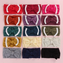 Set of fifteen colorful baby nylon headbands with large bows and white lace trim