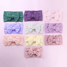 Flat lay of 10-piece set colorful nylon baby headbands with soft elastic fabric bows