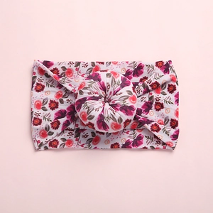 Detail shot of boho floral print baby headband with a soft nylon donut knot design