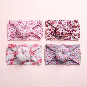 Detailed set of four floral baby headbands with donut knots on soft nylon bands