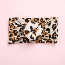 Detail of soft leopard print nylon headband with a donut knot for baby girls and kids