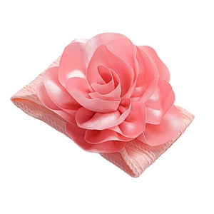 Pink soft nylon headband for babies featuring a large layered faux rose flower accessory