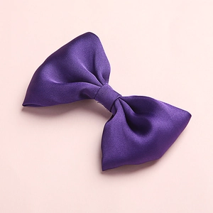 Macro detail of high-quality purple satin hair bow showing smooth texture and symmetry