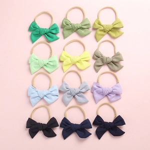 12-piece set of baby bow headbands in assorted Morandi colors with soft nylon elastic bands