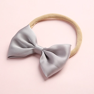 Detail of grey satin bow hairband with high-elastic nylon band for infants