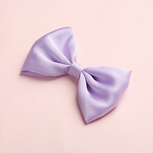 Detailed macro view of a lavender satin bow hair clip with fine silk texture and elegant sheen