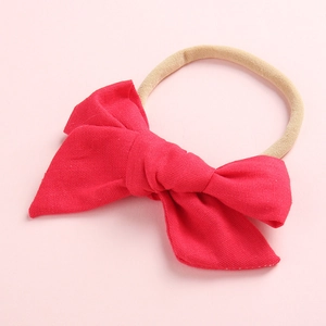 Close-up of baby headband with soft red cotton bow and high elastic nylon band