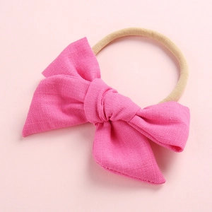 Detail of rose pink slub cotton bow headband with soft nude nylon elastic band