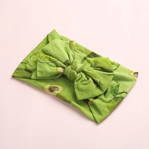 Green bohemian nylon baby headband with avocado and lime print and a large bow