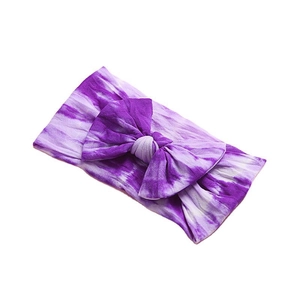 Purple tie-dye nylon baby headband with a large bow on a clean white background