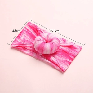 Detail view of pink tie-dye nylon headband with donut knot showing 15cm x 8.5cm size