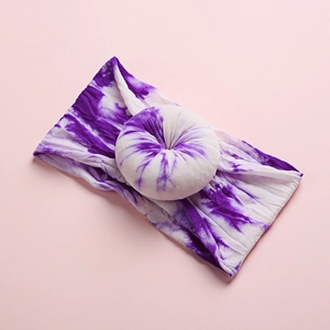 Detailed close-up of purple tie-dye baby nylon headband with ribbed donut knot texture