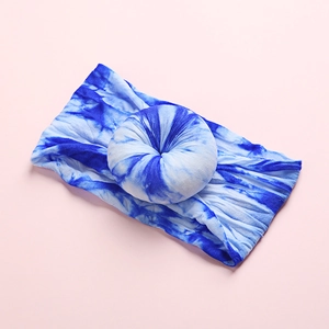 Close-up of baby nylon headband featuring blue and white tie-dye donut knot detail