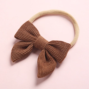 Detailed shot of brown corduroy bow with ultra-soft seamless nylon baby headband
