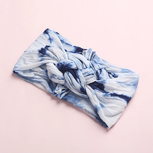 Detail of blue and white tie-dye knot headband in soft stretch fabric for infants