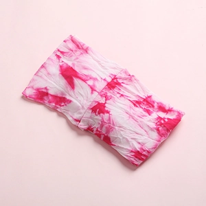 Detail shot of soft rose red tie-dye fabric headband with fine cotton knit texture