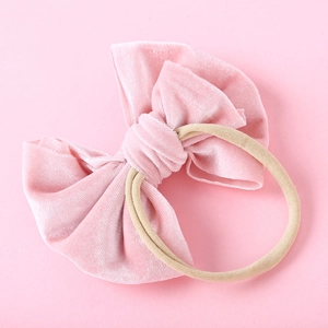 Detail eines rosa Samt-Stirnbands mit großer Schleife und weichem, elastischem Nylonband