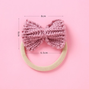 Detailed view of handmade knitted bow hair tie with size dimensions in dusty rose pink