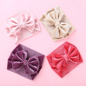 Set of four soft velvet baby bow headbands in pink, beige, purple and coral red colors