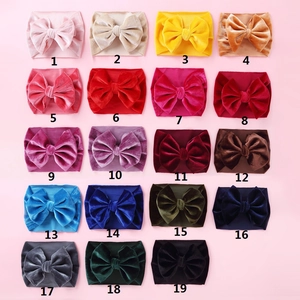 Detailed collection of 19 colorful velvet baby headbands with large bows in a grid layout