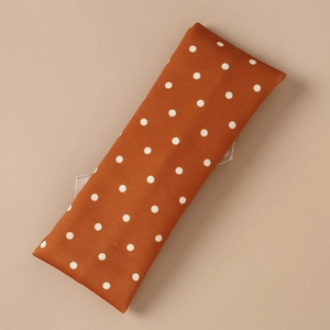 Detail of vintage orange fabric with white polka dots for children's elastic headband