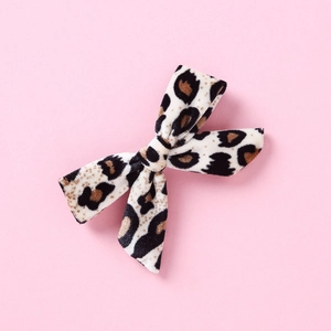 Detail of leopard print velvet hair bow with soft texture and neat edge stitching