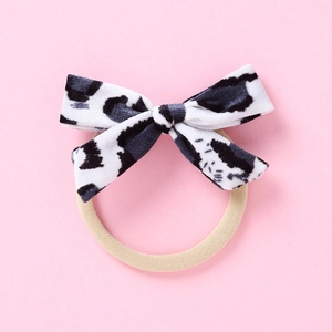 Détail du nœud en velours à motif vache avec bandeau élastique souple pour bébés