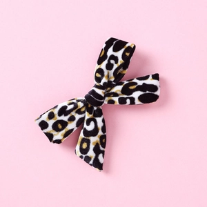 Detailed view of the leopard print velvet texture on a boutique girl hair bow clip