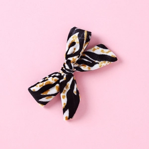 Detail of leopard print velvet bow hair clip for girls with soft animal texture