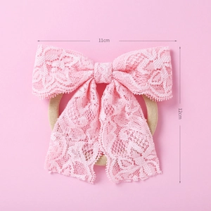 Vue détaillée du bandeau en dentelle rose avec nœud, dimensions 11cm par 12cm