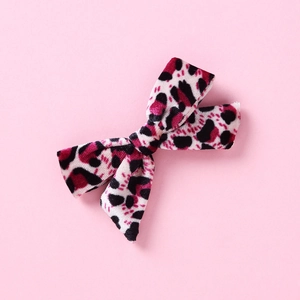 Close-up of pink leopard print velvet bow hair clip for girls with soft flocking texture