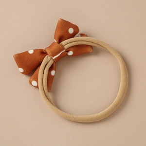 Retro brown polka dot bow headband with soft beige nylon hair band for babies