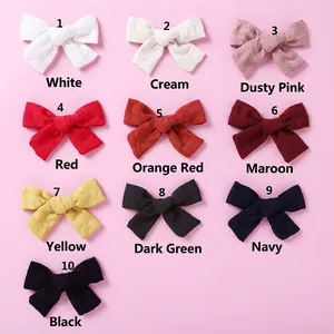 Detail view of 10 color options for cotton checkered bow clips for girls hair
