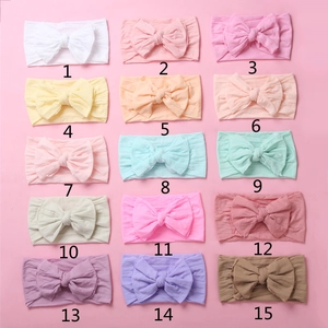 Detail view of 15 colorful soft nylon baby headbands with elegant double-layered bows