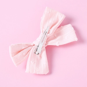 Detailed back view of a light pink cotton jacquard bow clip with silver metal alligator grip