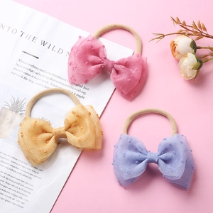 Trois bandeaux en nylon pour bébé avec grands nœuds en maille à pois rose et jaune