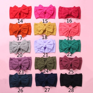 Detail showing 15 colorful soft nylon baby headbands with large double layered bow knots