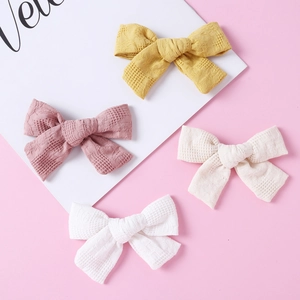 Set of four cotton plaid bow hair clips for girls in yellow, pink, beige, and white colors