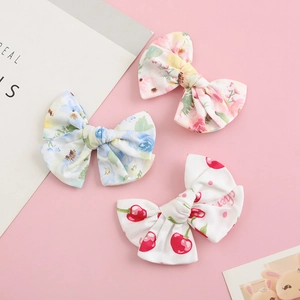 Three-piece set of cotton bow hair clips with pink floral and blue cherry prints