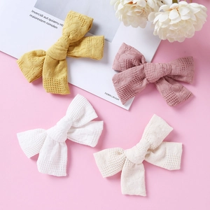 Set of four handmade cotton plaid bow hair clips for girls in yellow, purple, and white